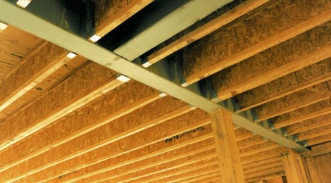 Construction phase - steel i-beams recessed in ceiling to pick up point loads from above custom homes by Rick Bernard.