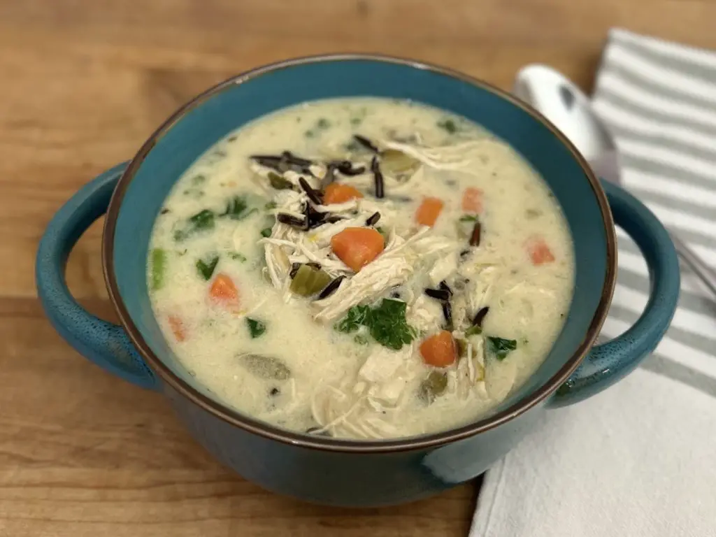 Chicken Wild Rice Soup in blue bowl with spoon.