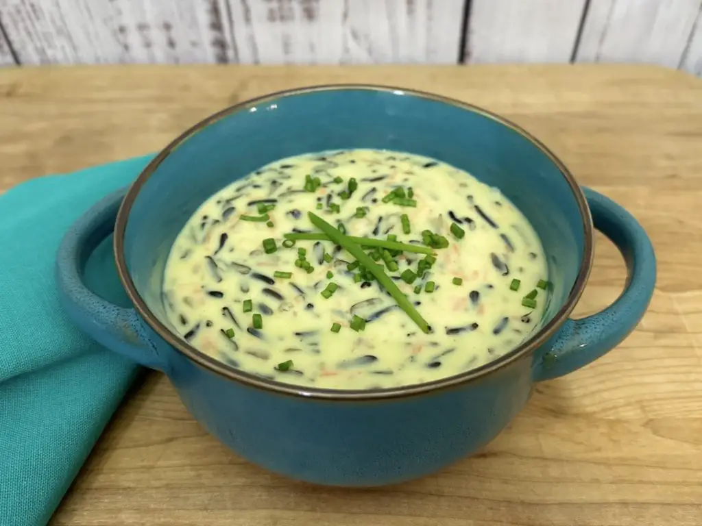 Minnesota Wild Rice Soup in a blue bowl with blue napkin on the side.