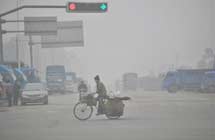 A man rides on a fog-shrouded road in Liuzhou City
