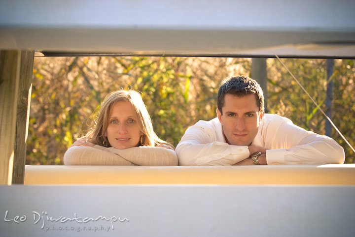 Engaged girl and guy posing by the canoes. Pre-wedding engagement photo session at Washington College and Chestertown, Maryland, by wedding photographer Leo Dj Photography.