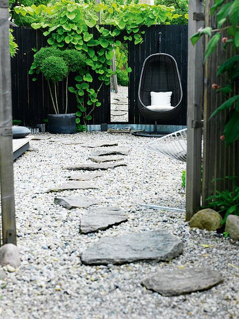 Love the contrast between light and dark. The greens pop so well against the fence. And the stone path looks great against the pea gravel.    outdoorgrey6.jpg by the style files, via Flickr