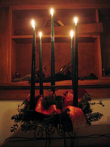 A candle centerpiece glows on Christmas day.