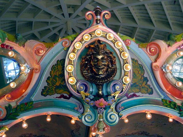 A jester smiles down on the watching crowds from the top of the Glen Echo Park carousel.