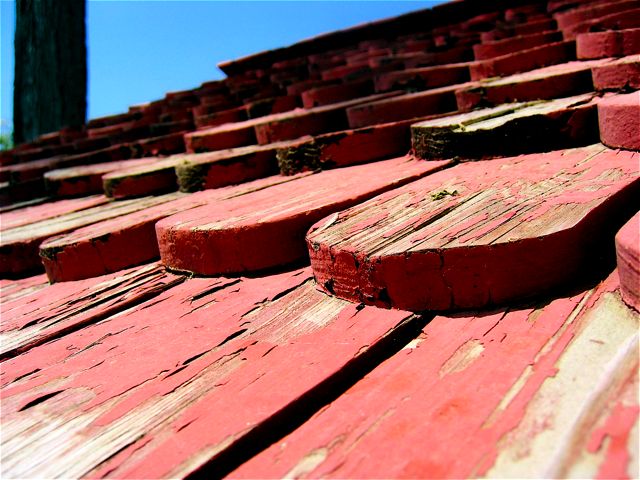 Paint peels from the ornate wooden shingles atop a side building at Mt. Vernon.