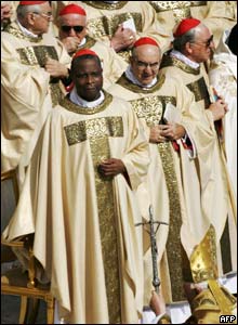 Cardinals from around the world watch as Pope Benedict makes his way towards the altar