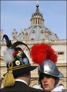 A Swiss Guard at the Vatican talks to a man in traditional Bavarian costume