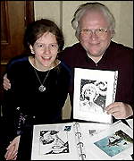 Artist Carolyn Edwards shows the sixth Doctor her portfolio