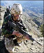 A marine from 45 Commando crouches with his weapon in Ginger Valley