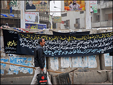 Man walking by blast wall