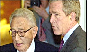 Henry Kissinger (L) and President George W Bush