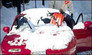 A resident in the Washington metropolitan area clears the windscreen