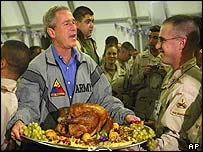 George W Bush serves turkey to US troops in Baghdad