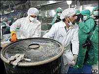 Two technicians carry a box containing yellowcake at the Iranian nuclear facility at Isfahan