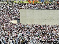 Pilgrims throw stones at the pillars on the Jamarat Bridge