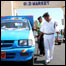 Police check underneath a car as it enters old town of Sharm al-Sheikh