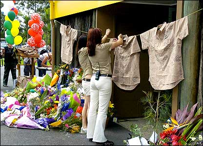 Staff hanging up signed shirts at Australia Zoo