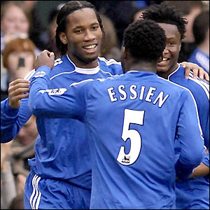 Drogba is congratulated by his team-mates after scoring