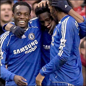 Michael Essien and Drogba celebrate with Obi