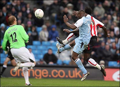 Jones nicks the ball over the advancing Nicky Weaver