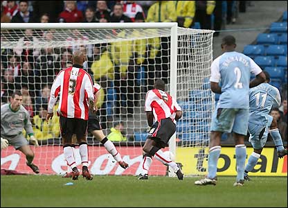 Vassell drives the ball towards goal