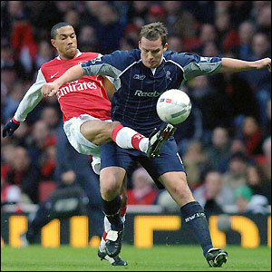 Gael Clichy and Kevin Davies contest possession