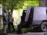 Police officers stand by with their armoured vehicle outside the Moscow police department, May 20, 2007