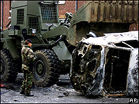 A soldier clears up after a loyalist riot