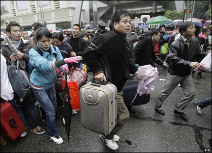 Passengers rush to a bus which will take them to Guangzhou train station, China (30/01/2008)