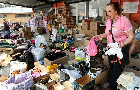 Volunteers sort through tonnes of donated goods at the Whittlesea relief centre