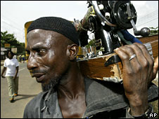 Man carrying sewing machine