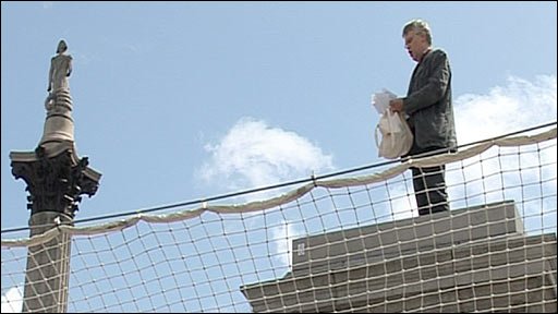 A man stands on the fourth plinth in Trafalgar Square