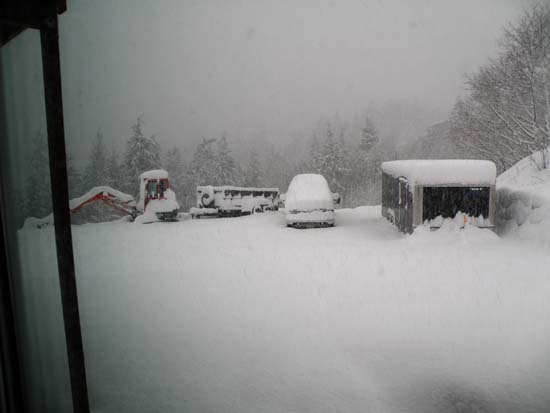 Driveway covered in snow, Toyota Prius buried.