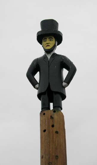 Abraham Lincoln on top of a totem pole.