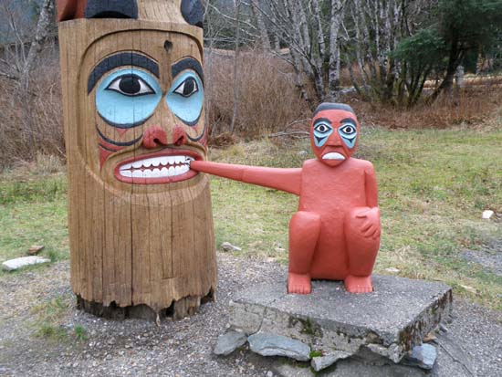 Hand being eaten by totem pole