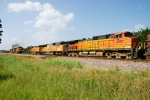 BNSF 5436, CSX 920, BNSF 4702 (sb) aggregate passes BNSF 7806, UP 5038, BNSF 4087 (nb) running long hood forward on point of Herzog ballast empties