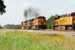 BNSF 5436, CSX 920, BNSF 4702 (sb) aggregate passes BNSF 7806, UP 5038, BNSF 4087 (nb) running long hood forward on point of Herzog ballast empties