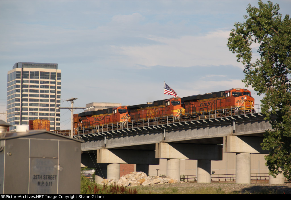 BNSF 6982 Rolls a stack over the flyover into the setting sun.