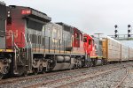 A long Westbound mixed freight with autoracks  tank cars and boxcars