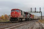 A long Westbound mixed freight with autoracks  tank cars and boxcars