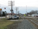 The maintainer cleans up the debris as Q326 waits to proceed