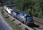 Still looking like Conrail one year after takeover. Norfolk Southern Electro-Motive Division SD-70 2560 swings eastbound around the curve and heads toward THE Curve 