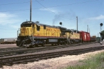 Union Pacific GE C-30-7 2431 and EMD GP-35 741 are heading passed the Amtrak station with a mixed freight 