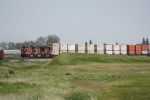 A Hot Doublestack Train Rounds a Curve Heading West out of Town