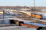 BNSF passing thru the yard as a BNSF "Smurf" waits