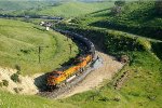 BNSF 4455 pushes hard as a manifest freight climbs the pass