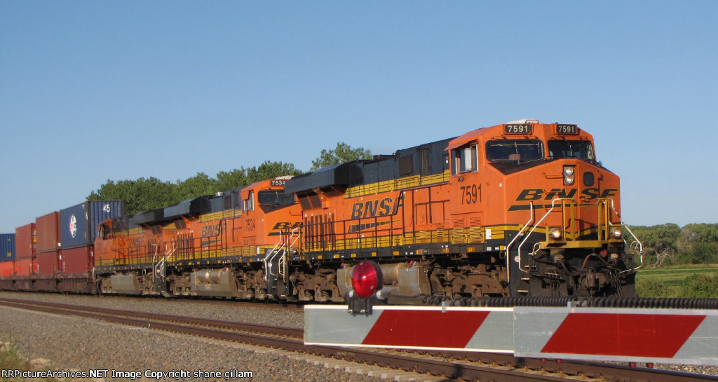 BNSF 7591 is heading into afternoon sun.