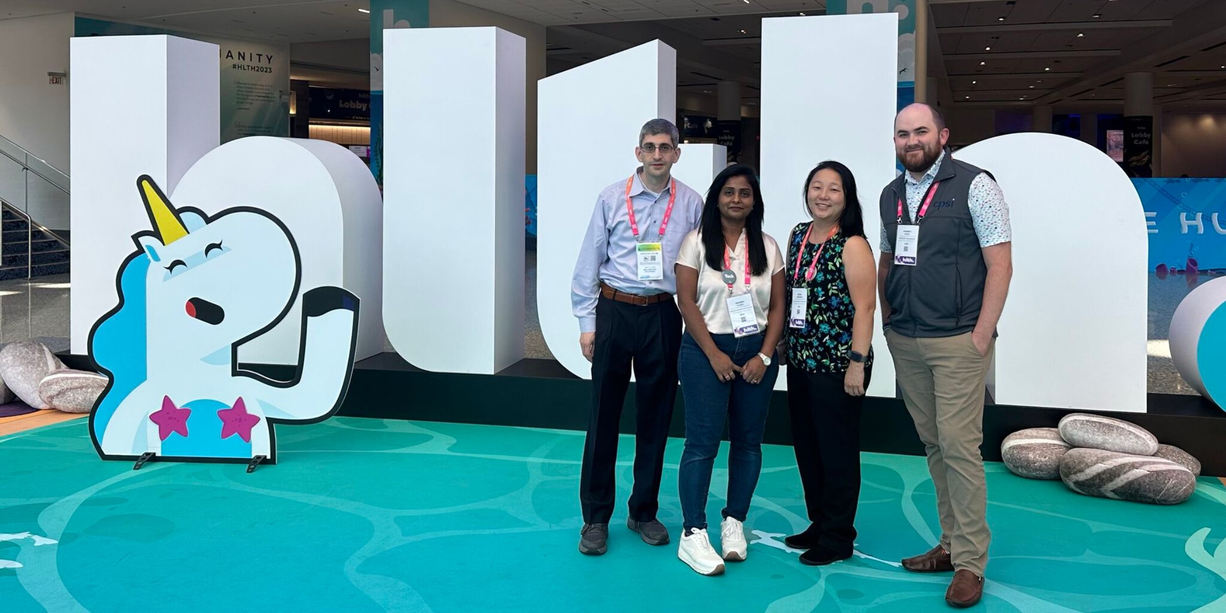 People posing in front of conference sign