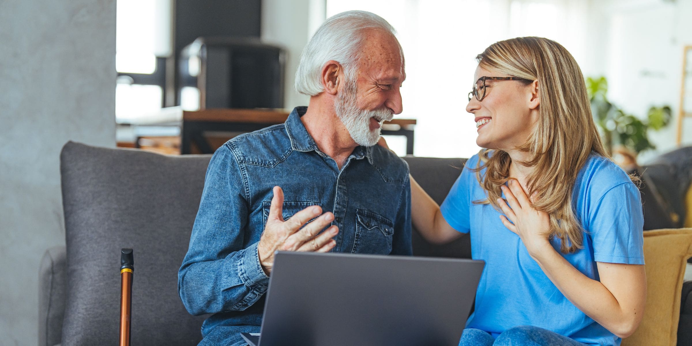 Elderly man receiving assistance from female nurse