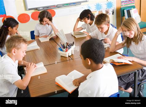 Students in class reading books Stock Photo - Alamy